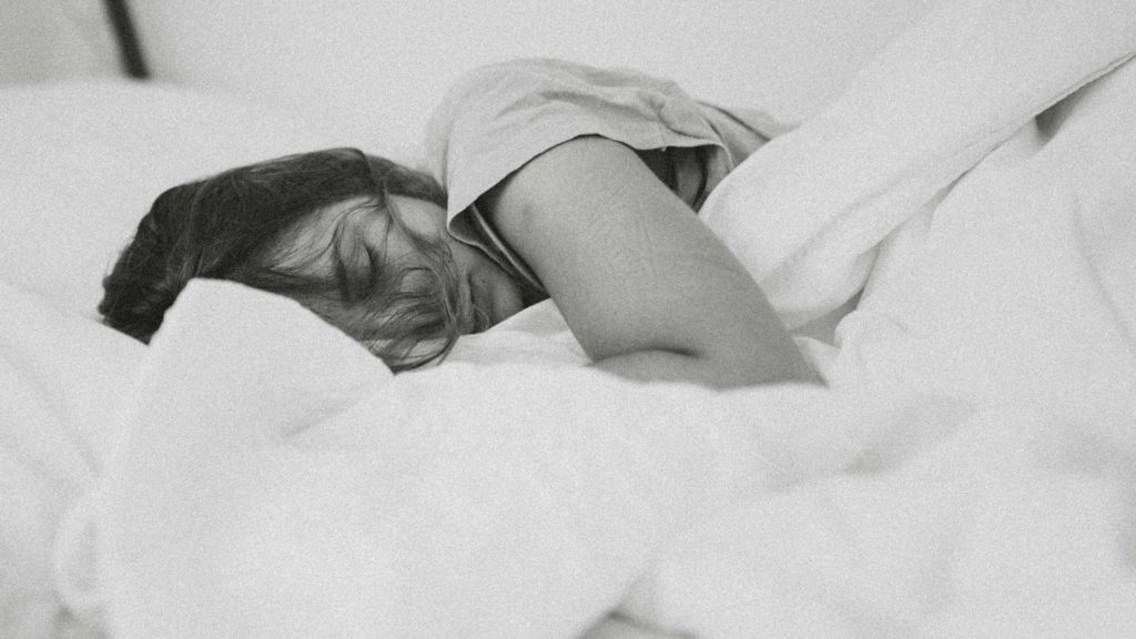 Frau liegt im Bett und schläft