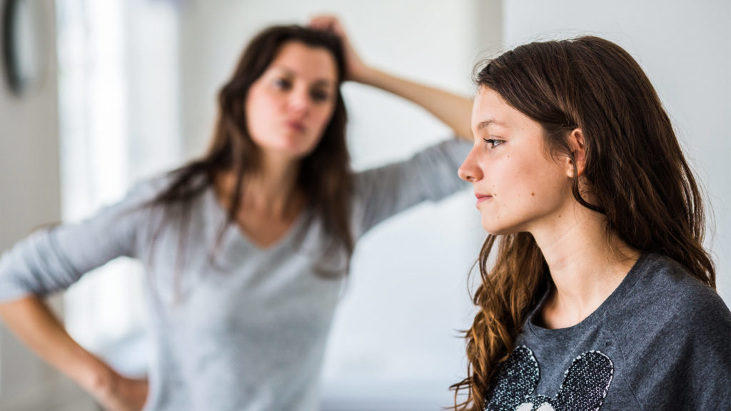 Mädchen und Mutter stehen genervt voreinander. Die Mutter rauft sich die Haare.